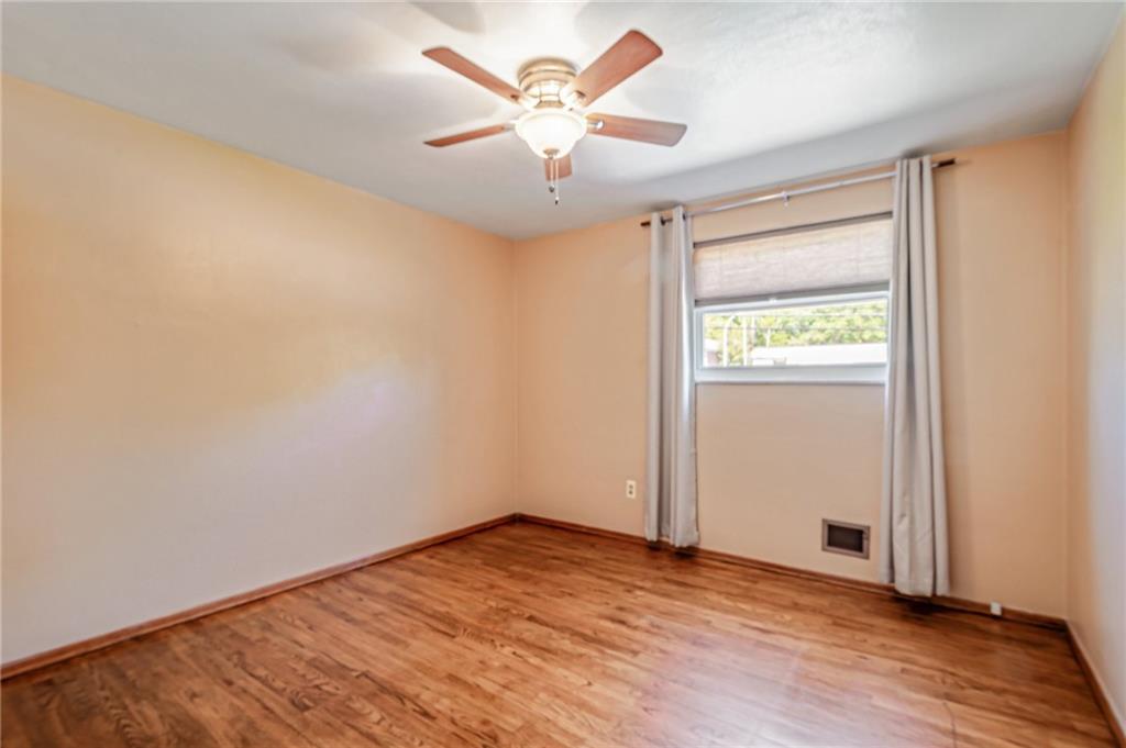 5000 Homeville Road West Mifflin, PA 15122 - Photo 14 of 24 an empty room with wooden floor and windows