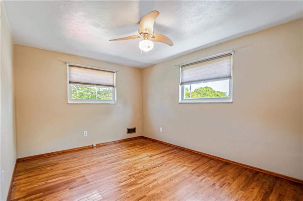 5000 Homeville Road West Mifflin, PA 15122 - Photo 15 of 24 a view of an empty room with wooden floor and a window