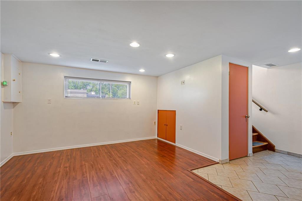 5000 Homeville Road West Mifflin, PA 15122 - Photo 19 of 24 a view of an empty room with wooden floor and a ceiling fan