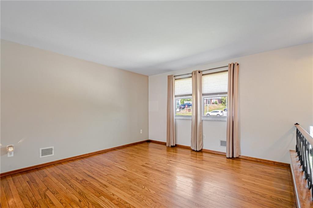 5000 Homeville Road West Mifflin, PA 15122 - Photo 5 of 24 wooden floor in an empty room with a window