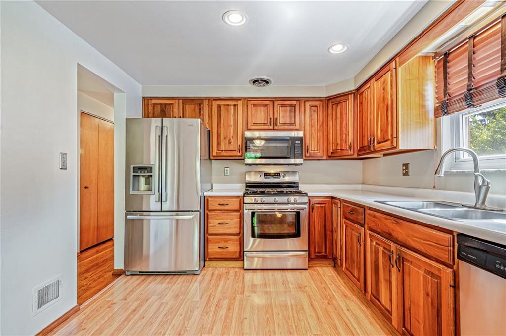 5000 Homeville Road West Mifflin, PA 15122 - Photo 7 of 24 a kitchen with stainless steel appliances granite countertop a refrigerator stove and sink