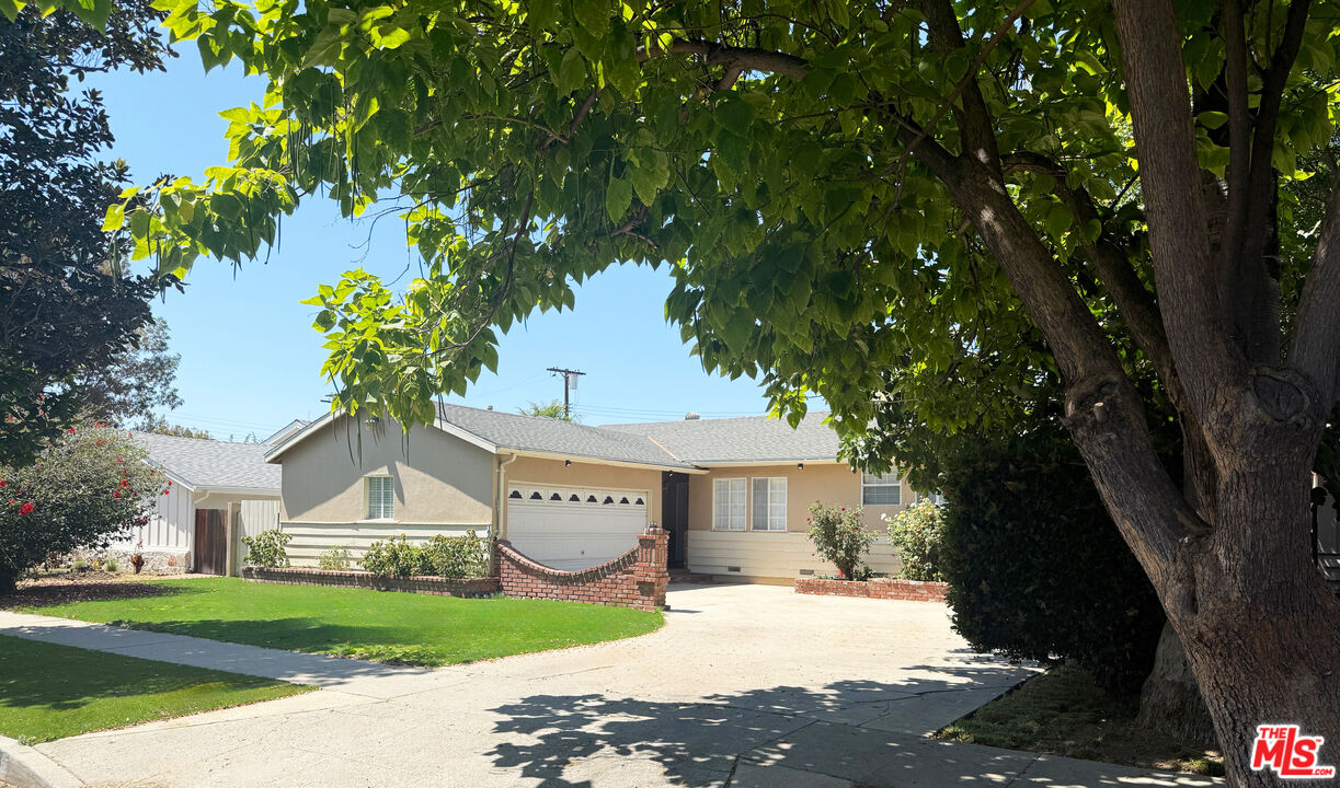 19023 Cantlay Street Reseda, CA 91335 - Photo 1 of 17 a front view of a house with a yard and tree