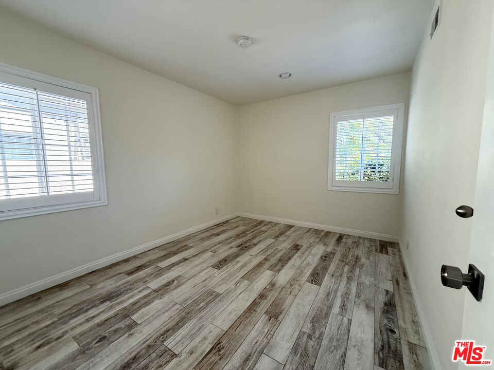 19023 Cantlay Street Reseda, CA 91335 - Photo 11 of 17 a view of empty room with wooden floor