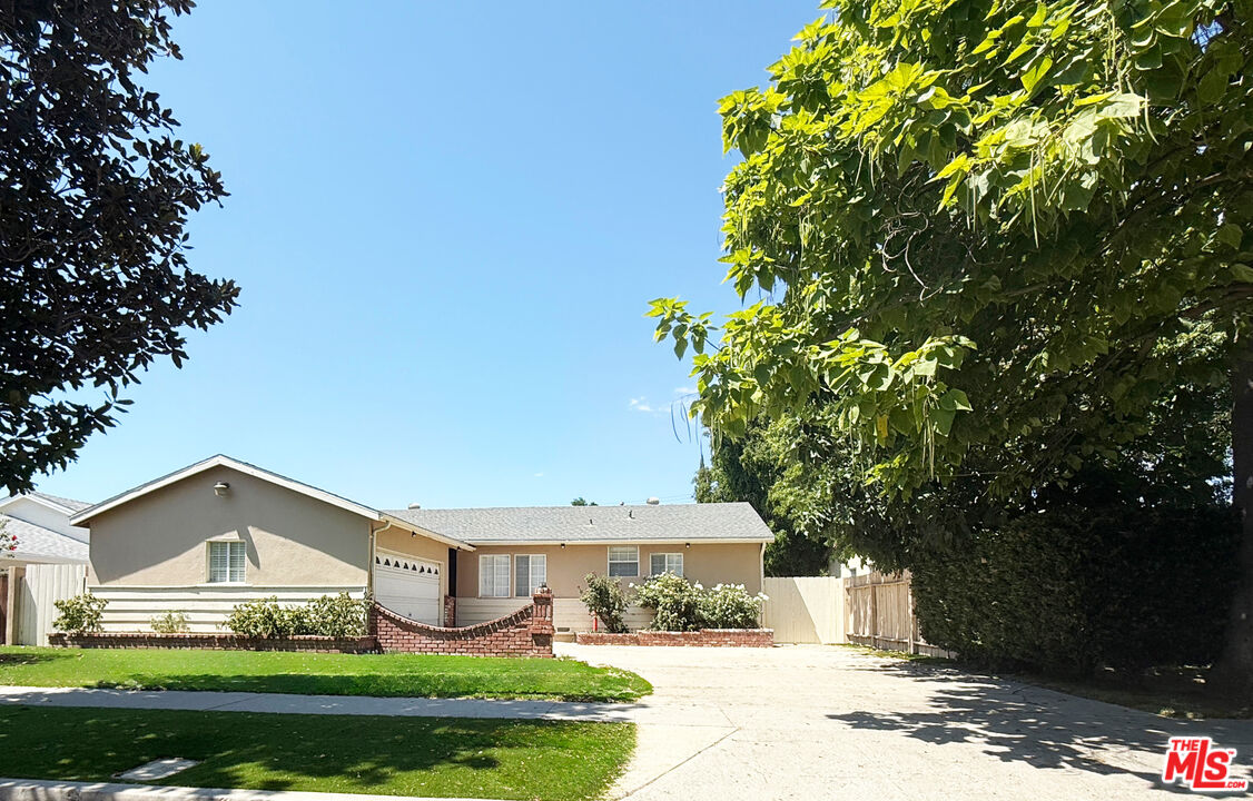 19023 Cantlay Street Reseda, CA 91335 - Photo 2 of 17 a front view of a house with a yard