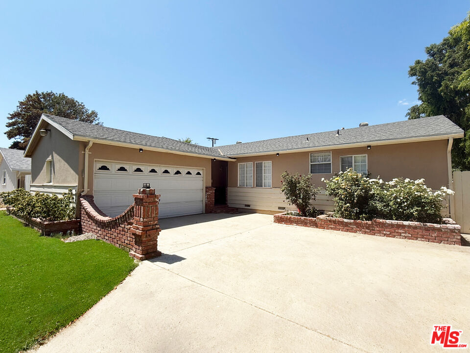 19023 Cantlay Street Reseda, CA 91335 - Photo 3 of 17 a view of a house with a yard and potted plants