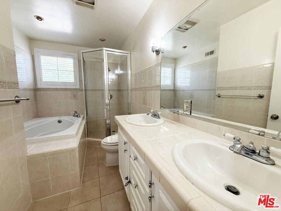 19023 Cantlay Street Reseda, CA 91335 - Photo 9 of 17 a bathroom with a granite countertop sink a toilet and shower