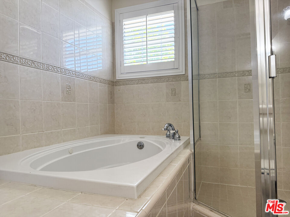19023 Cantlay Street Reseda, CA 91335 - Photo 10 of 17 a white bath tub and shower