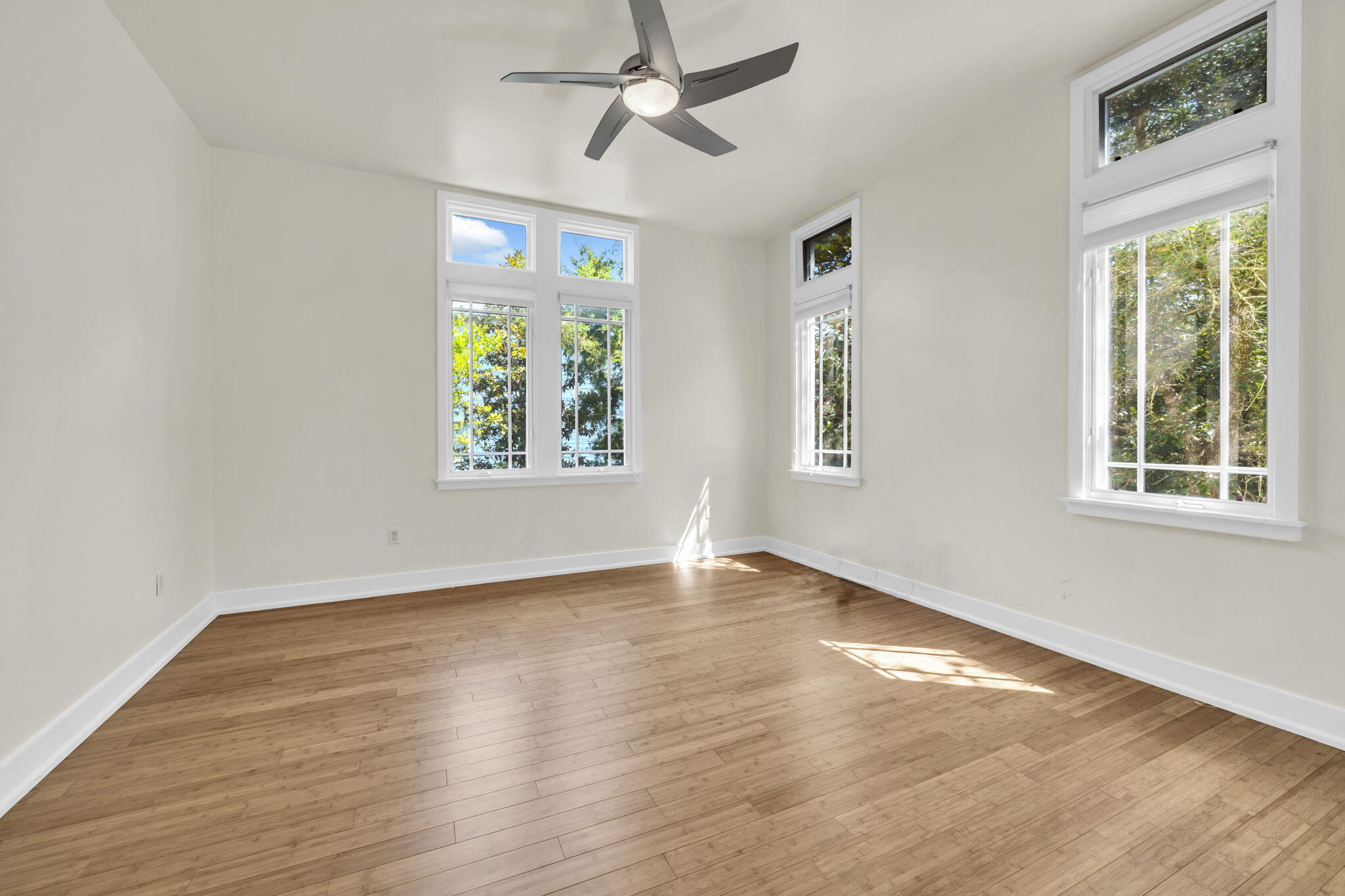 286 Forest Street Santa Rosa Beach, FL 32459 - Photo 19 of 68 a view of an empty room with wooden floor and a window