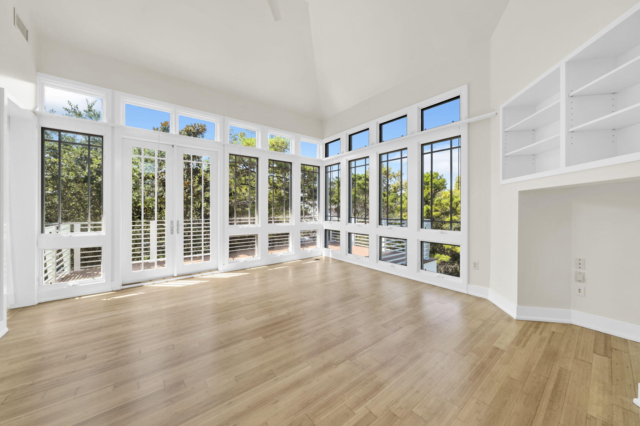 286 Forest Street Santa Rosa Beach, FL 32459 - Photo 28 of 68 a view of an empty room with wooden floor and windows