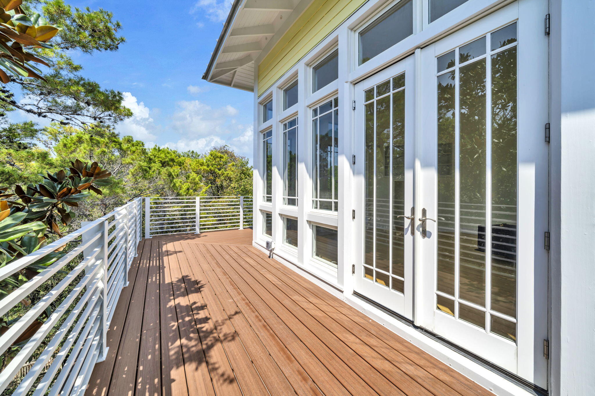 286 Forest Street Santa Rosa Beach, FL 32459 - Photo 30 of 68 a view of balcony with wooden floor and fence and floor to ceiling window