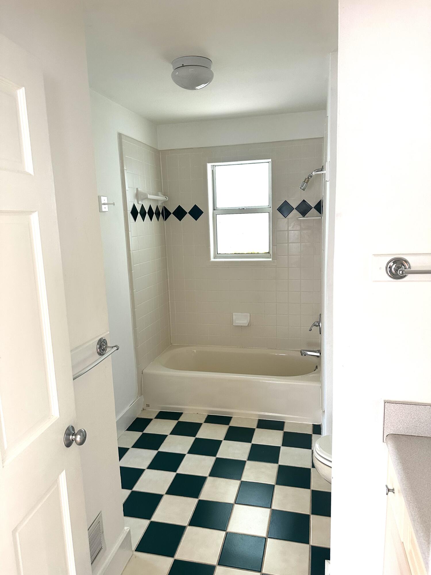 286 Forest Street Santa Rosa Beach, FL 32459 - Photo 61 of 68 a bathroom with a black and white checkered floor