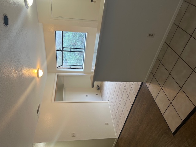501 Hedgewood Drive, Unit D Georgetown, TX 78628 - Photo 4 of 15 Empty room with a textured ceiling and light tile patterned floors