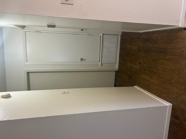 501 Hedgewood Drive, Unit D Georgetown, TX 78628 - Photo 7 of 15 Hallway featuring wood finished floors and a textured wall