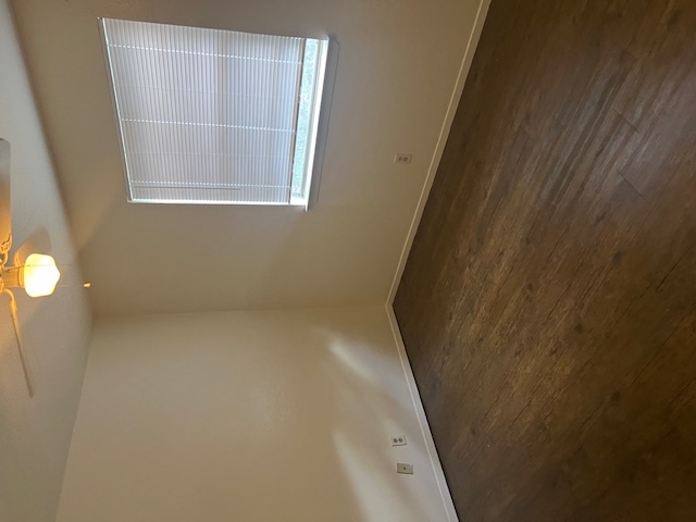 501 Hedgewood Drive, Unit D Georgetown, TX 78628 - Photo 8 of 15 Empty room with a ceiling fan and dark wood finished floors