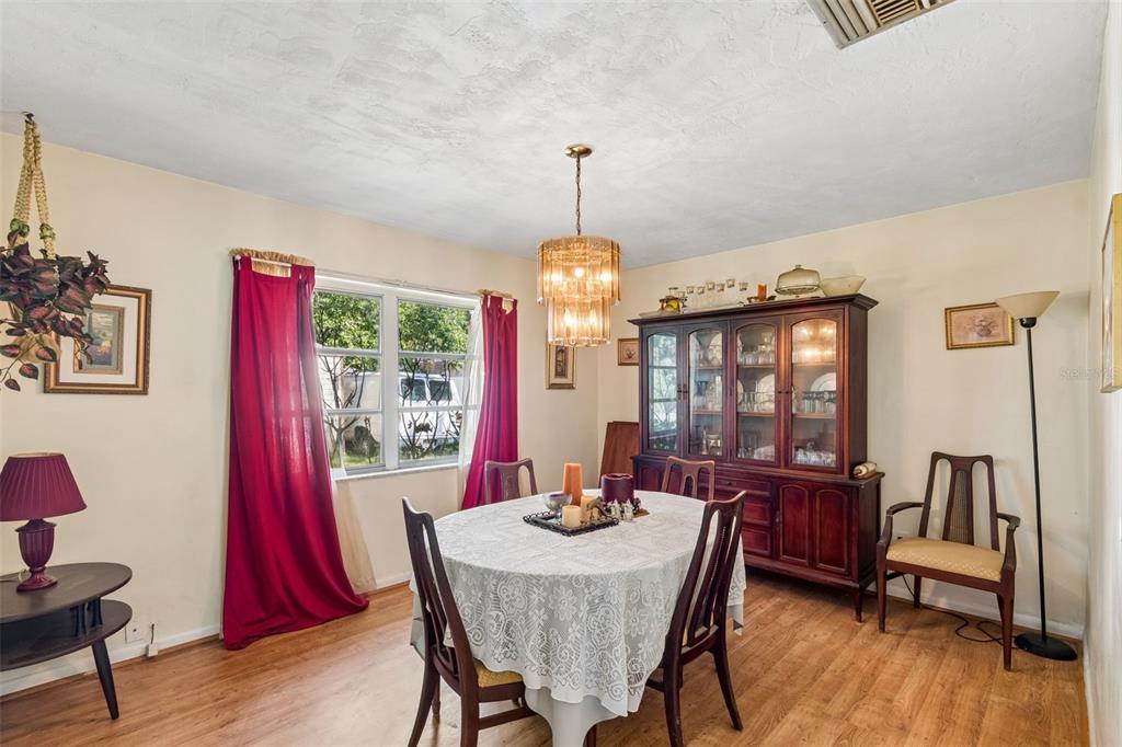 2059 Waterfall Drive Spring Hill, FL 34608 - Photo 10 of 26 a dining room with furniture window and wooden floor