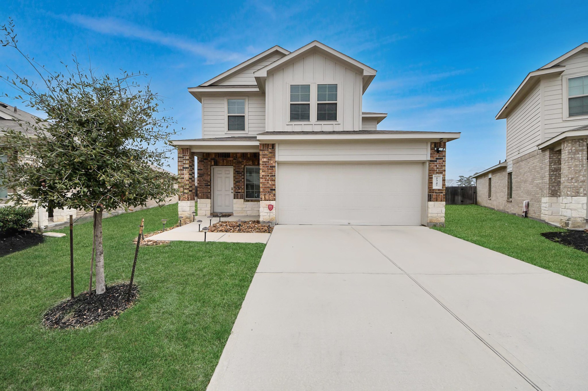 2347 Pettingell Way Spring Spring, TX 77373 - Photo 2 of 41 Inviting front exterior with manicured lawn, driveway parking, and modern suburban charm.
