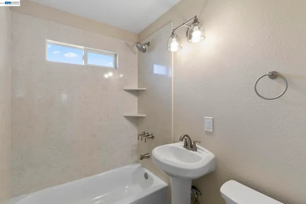 a bathroom with a sink toilet and a mirror