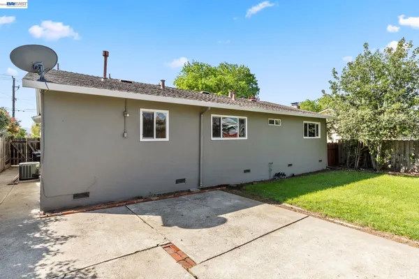 a backyard of a house with potted plants