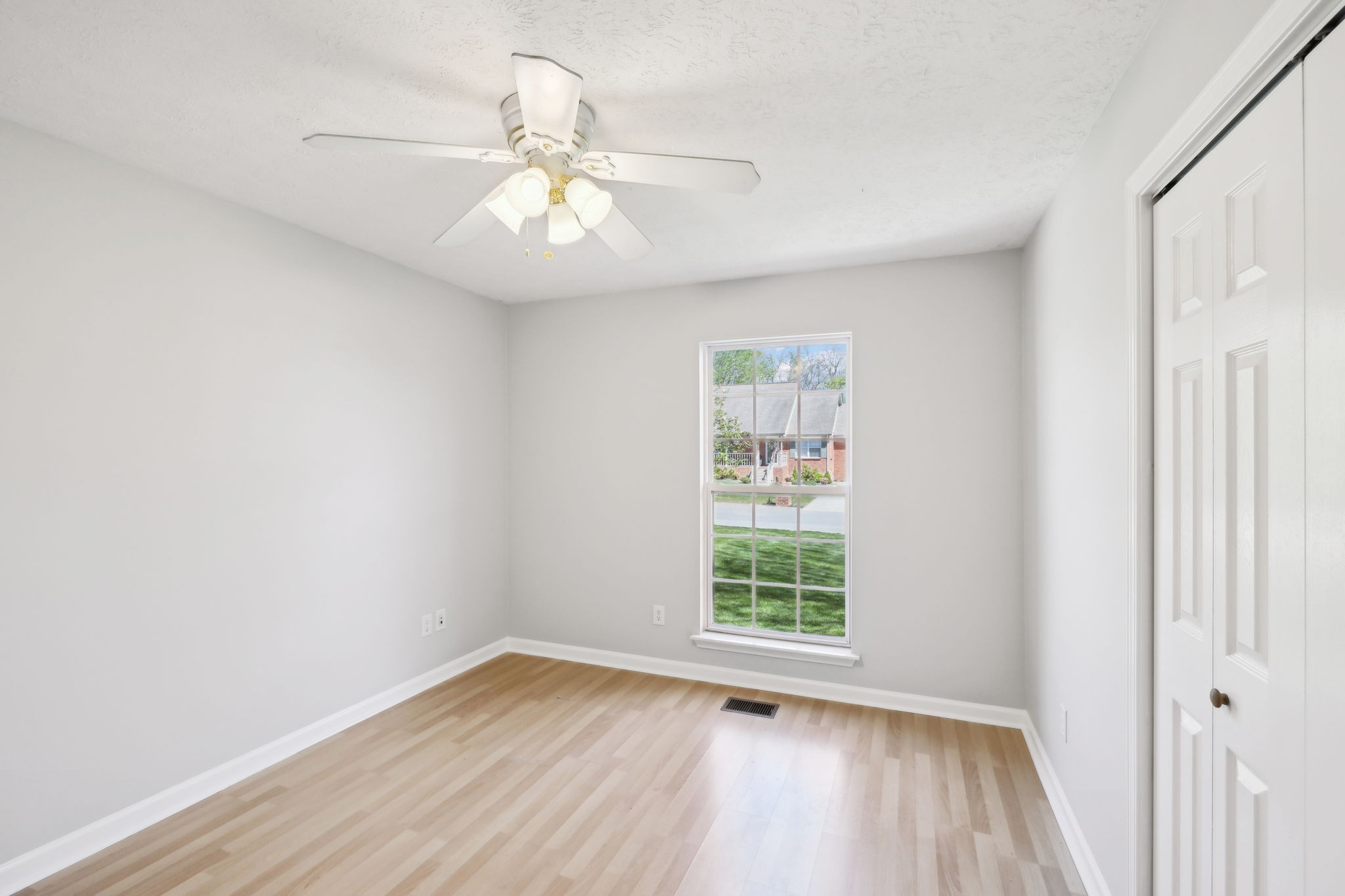 623 Audrey Road Mount Juliet, TN 37122 - Photo 17 of 27 an empty room with wooden floor fan and windows