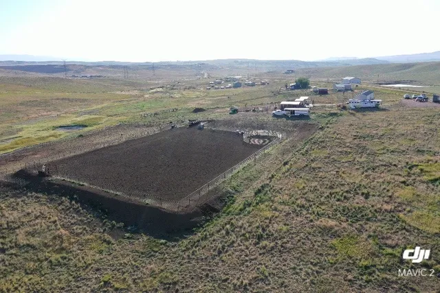 a kitchen with a refrigerator a stove top oven a counter space and wooden floor