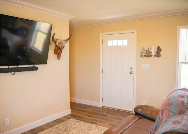 a walk in closet with wooden floor