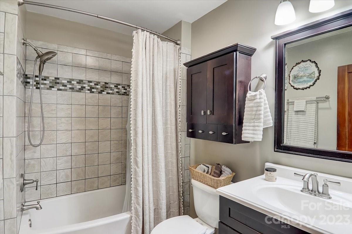 1393 Queentown Road Canton, NC 28716 - Photo 20 of 42 a bathroom with a granite countertop sink mirror toilet and bathtub