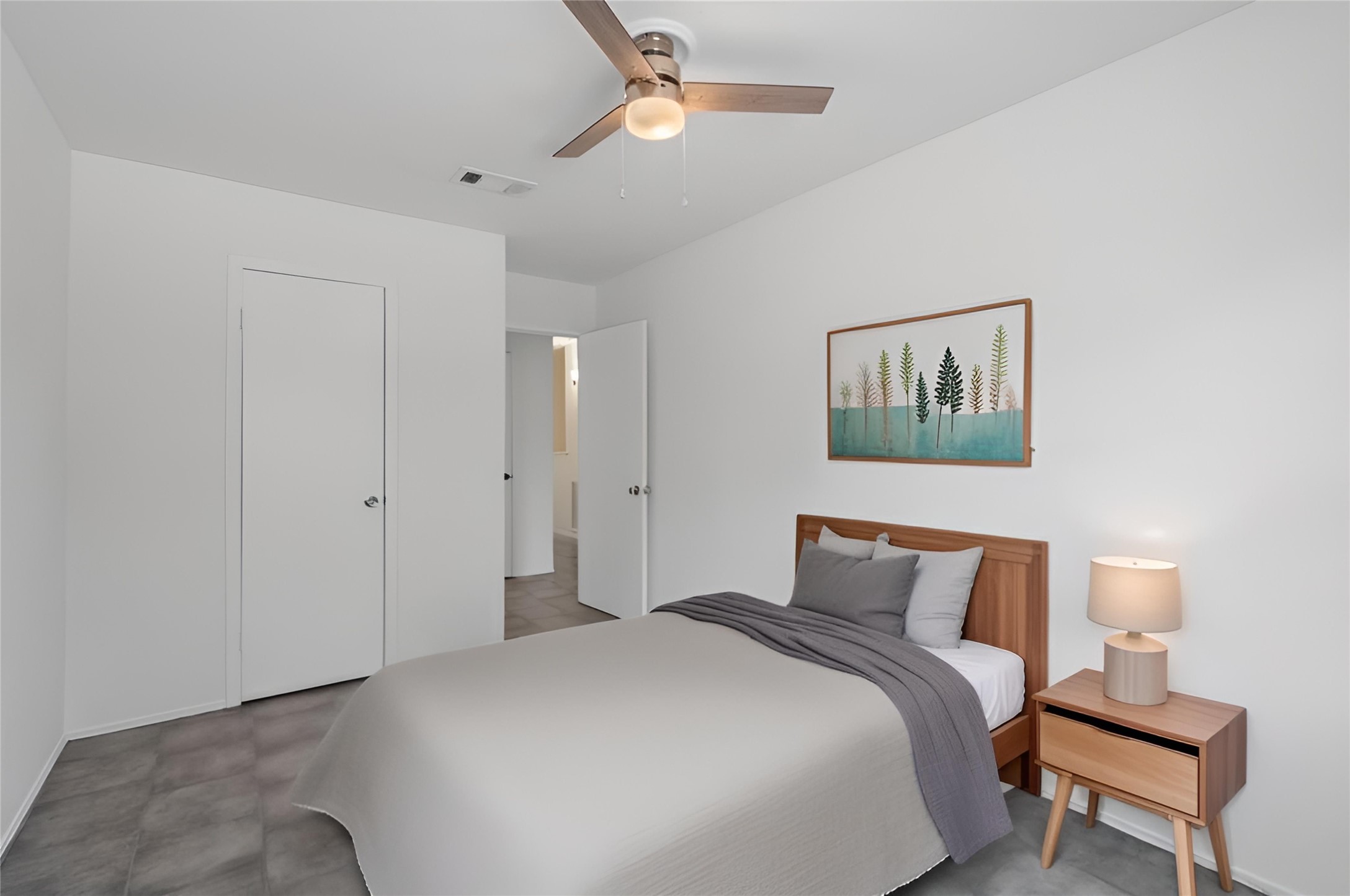 5801 Lumberdale Road, Unit 127 Houston, TX 77092 - Photo 11 of 26 a bedroom with a bed and a lamp on a dresser