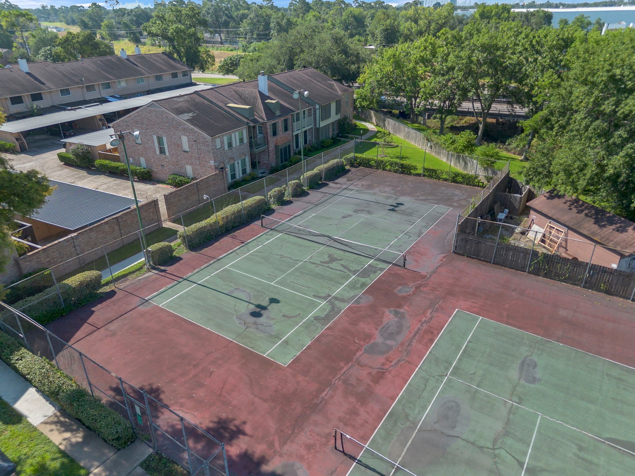 5801 Lumberdale Road, Unit 127 Houston, TX 77092 - Photo 20 of 26 an aerial view of a tennis ground with a white house