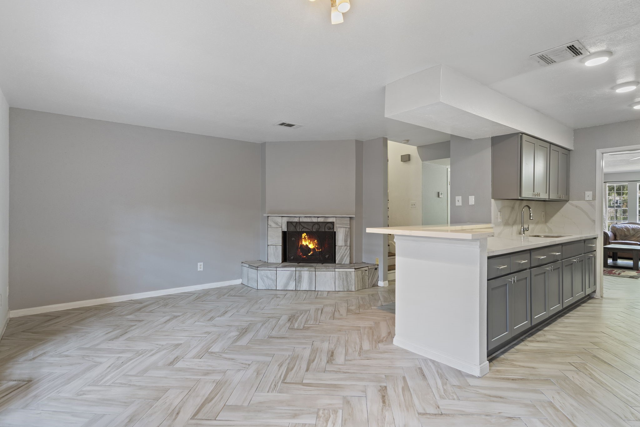 5801 Lumberdale Road, Unit 127 Houston, TX 77092 - Photo 8 of 26 a large white kitchen with a fireplace and wooden floor