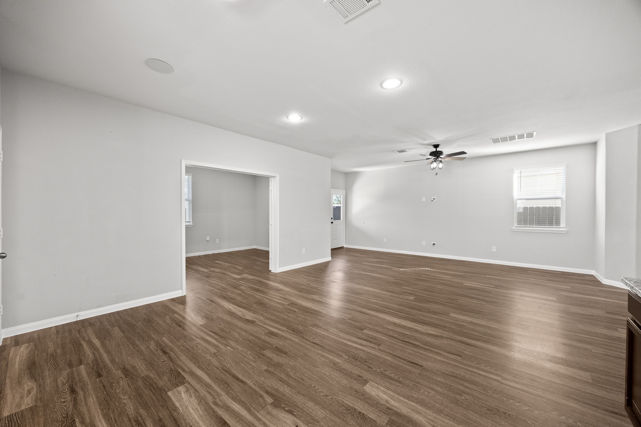 18606 Lansdowne Stream Path Katy, TX 77449 - Photo 24 of 39 an empty room with wooden floor and windows