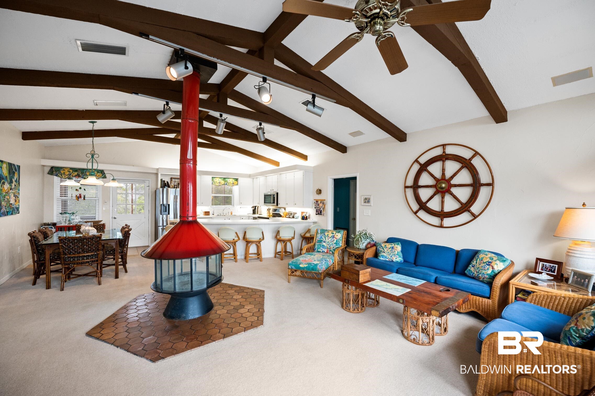 30388 River Road Orange Beach, AL 36561 - Photo 30 of 72 Living room featuring vaulted ceiling with beams, a wood stove, ceiling fan, and visible vents