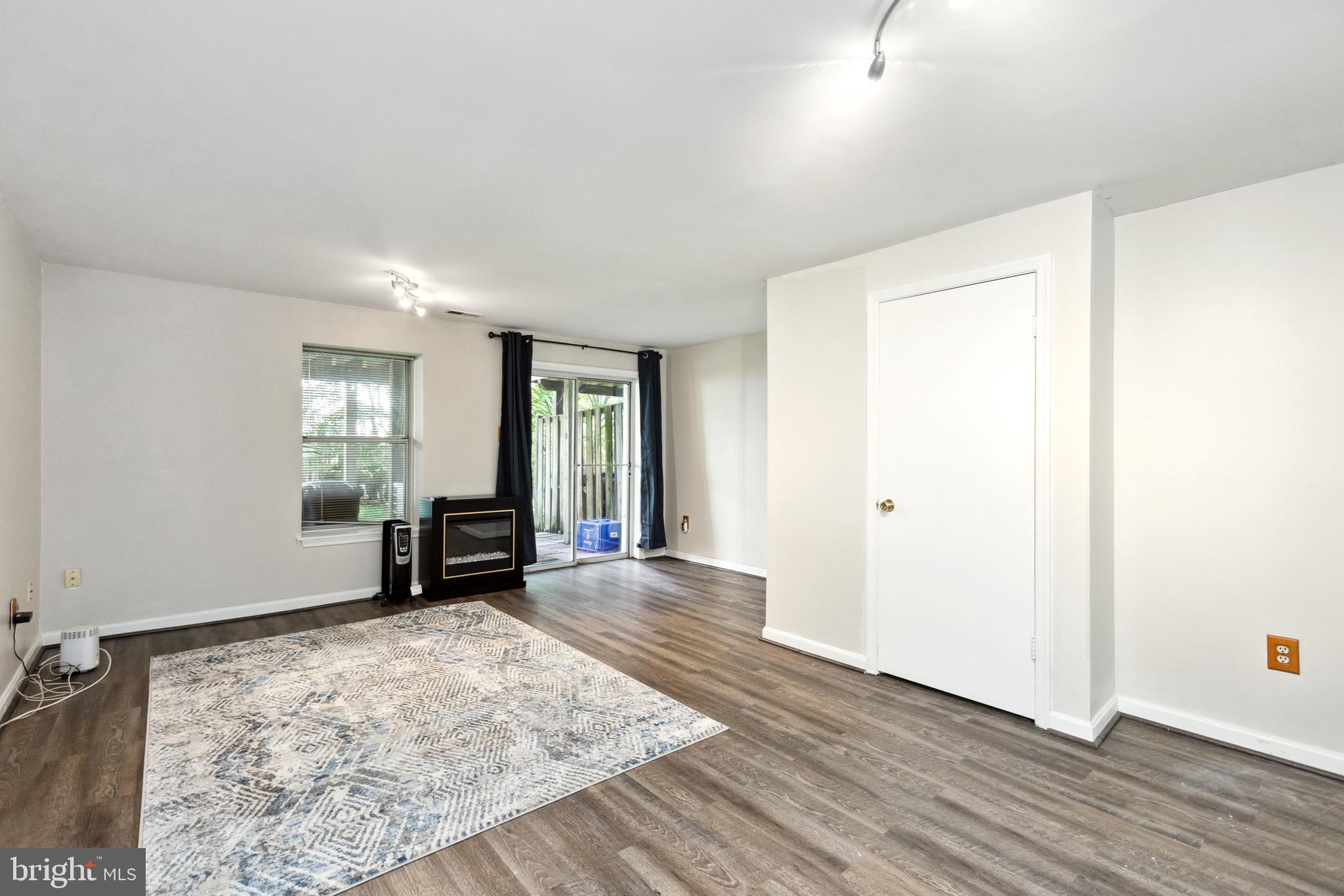 9525 Clocktower Lane Columbia, MD 21046 - Photo 16 of 19 a view of a room with wooden floor and window