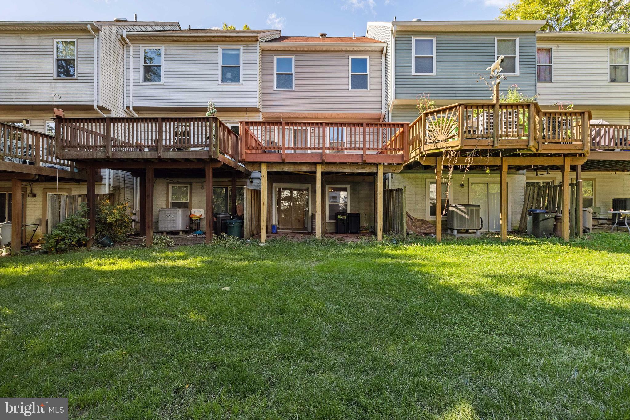 9525 Clocktower Lane Columbia, MD 21046 - Photo 19 of 19 a front view of a house with a garden and deck