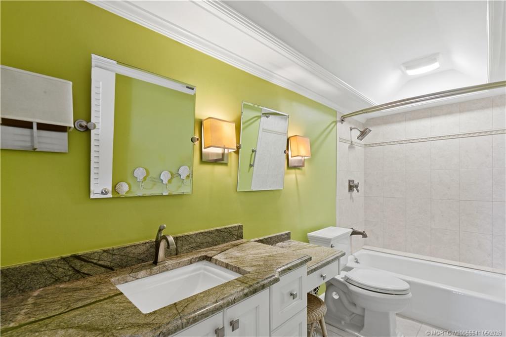 1866 Southwest Palm City Road, Unit 204 Stuart, FL 34994 - Photo 22 of 38 a bathroom with a granite countertop sink toilet and shower