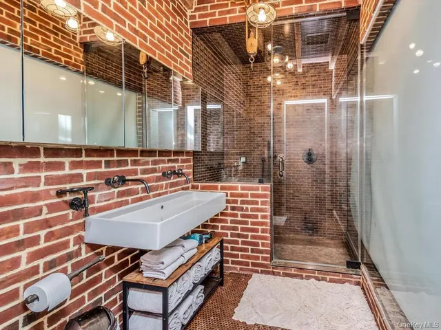 a outdoor space with lots of white furniture and shower