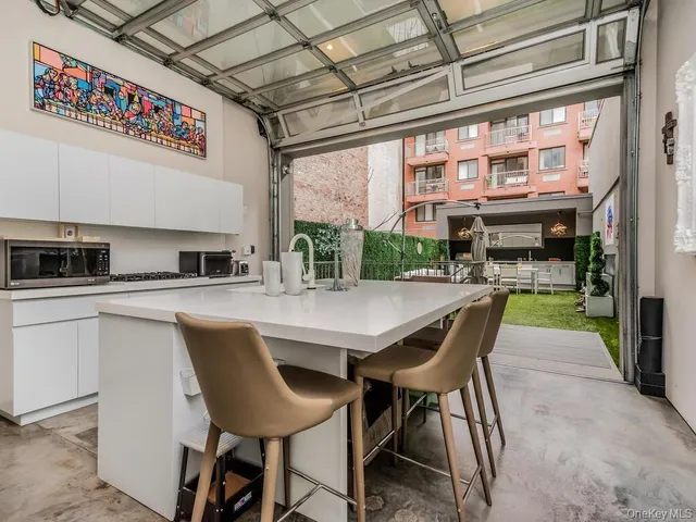 a kitchen with a table chairs and a window