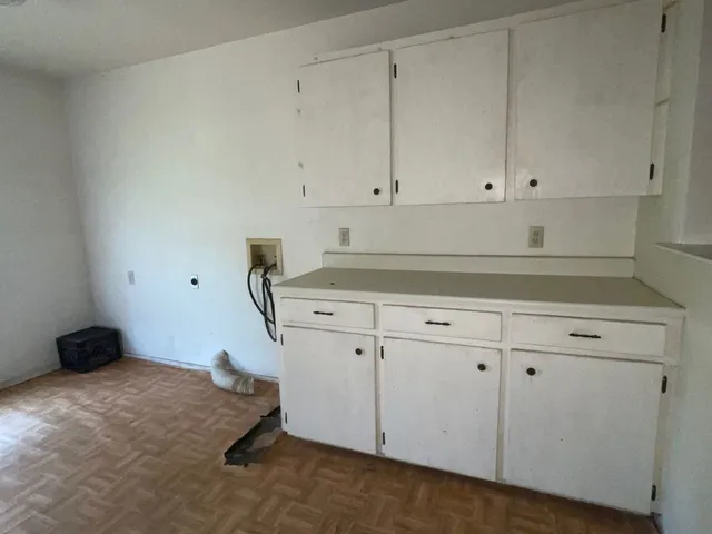a kitchen with white cabinets
