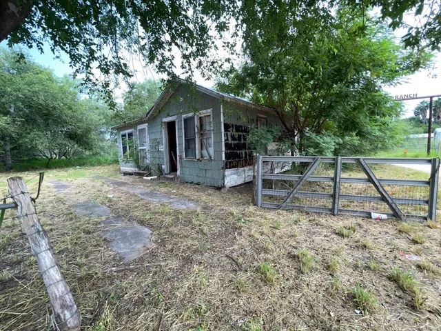 a wooden bench sitting in front of a house