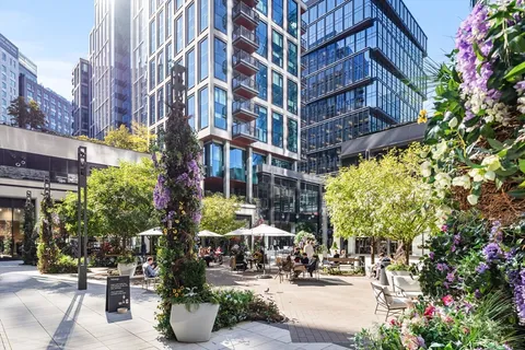 a building with lots of flowers and trees
