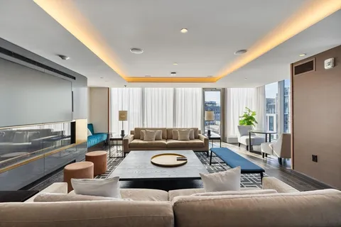 a room with view of a living room and dining table