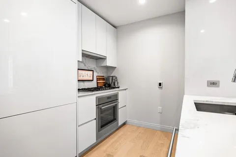 a kitchen with a sink cabinets and stainless steel appliances