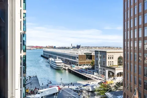 a view of a lake with tall buildings