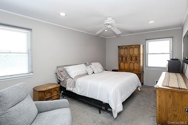 1102 Lawrence Road Bellmore, NY 11710 - Photo 19 of 33 King Size Bedroom! Recessed ceiling lighting, crown molding, two windows, ceiling fan, and carpeted flooring