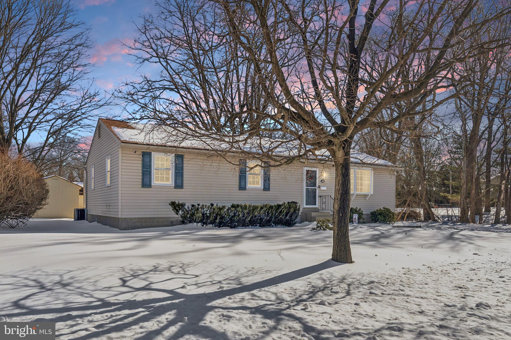 404 Enfield Road Oreland, PA 19075 - Photo 1 of 43 a front view of a house with a yard covered in snow