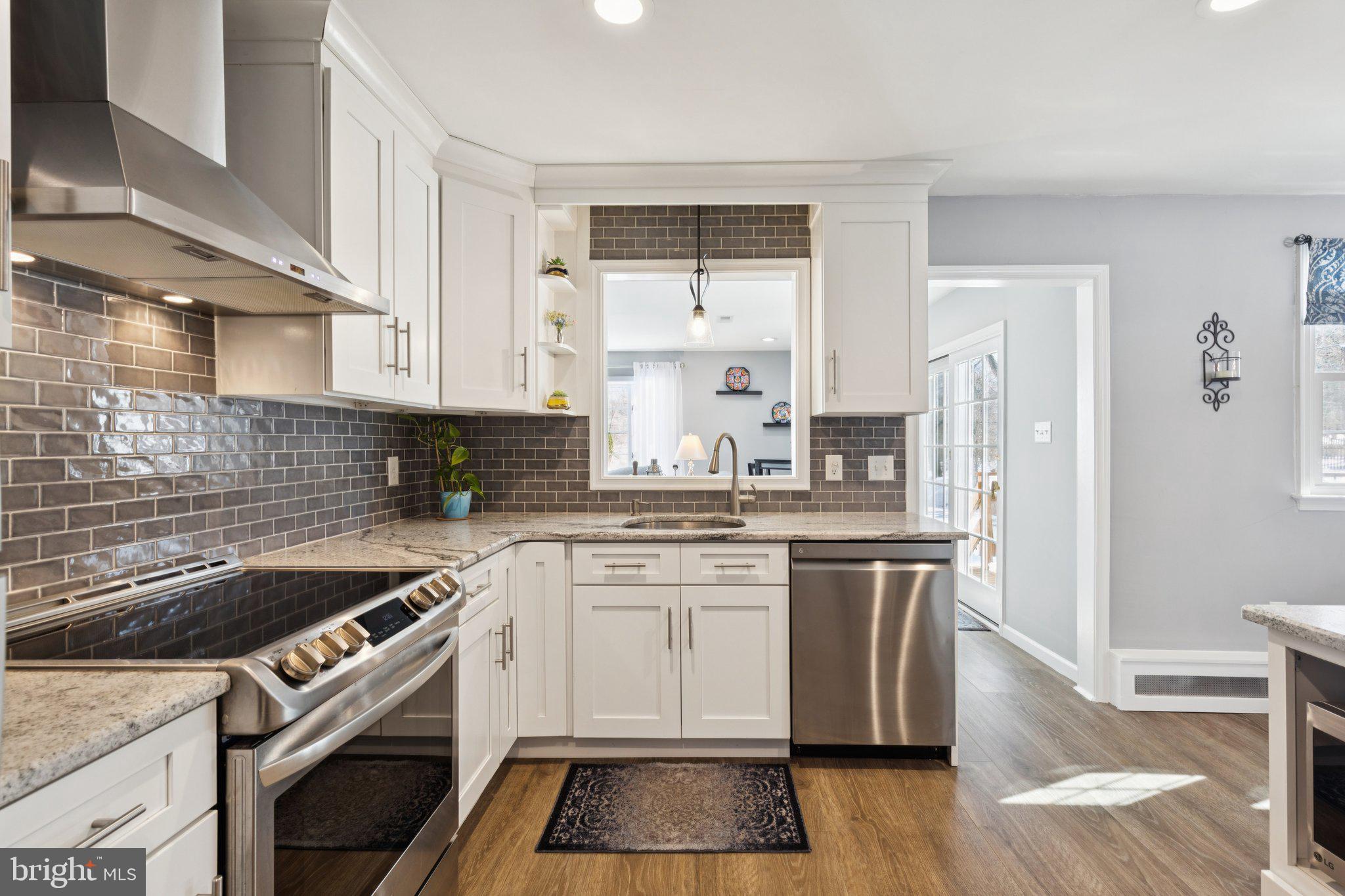 404 Enfield Road Oreland, PA 19075 - Photo 2 of 43 a kitchen with a white cabinets and white appliances