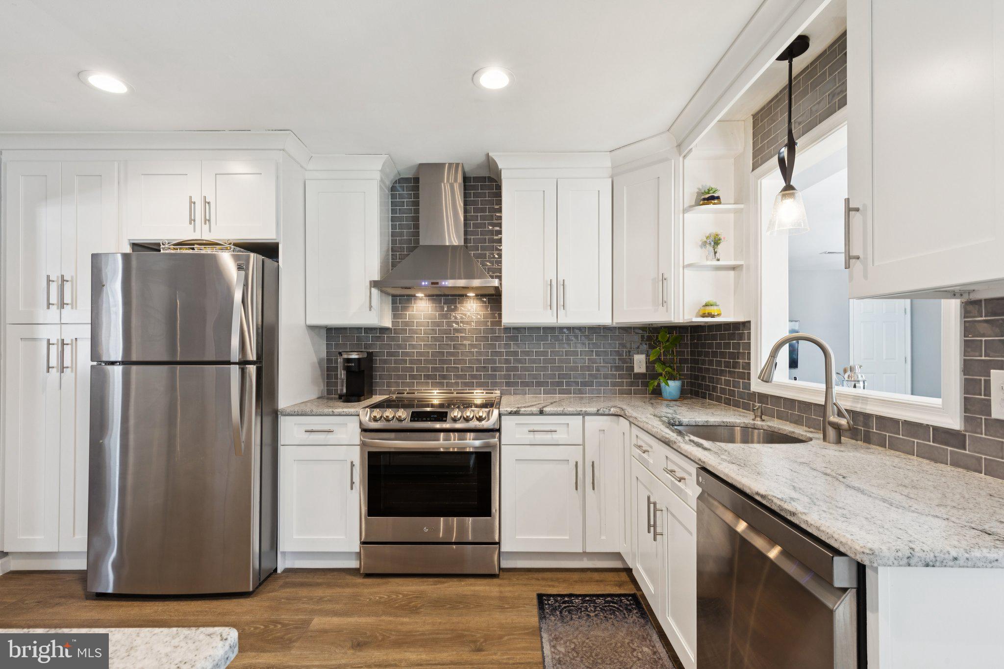 404 Enfield Road Oreland, PA 19075 - Photo 9 of 43 a kitchen with a refrigerator sink and stainless steel appliances