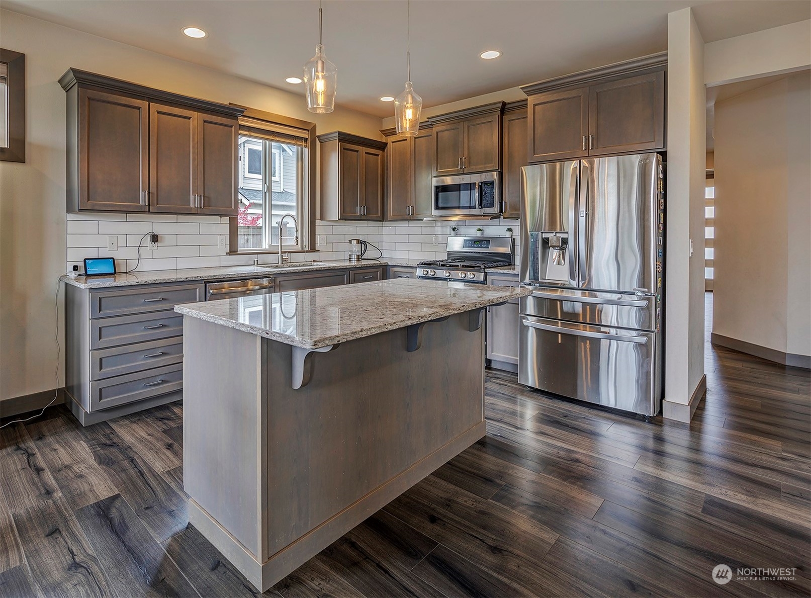 4015 147th Place Southeast Bothell, WA 98012 - Photo 13 of 31 a kitchen with stainless steel appliances granite countertop a stove top oven a sink and a refrigerator