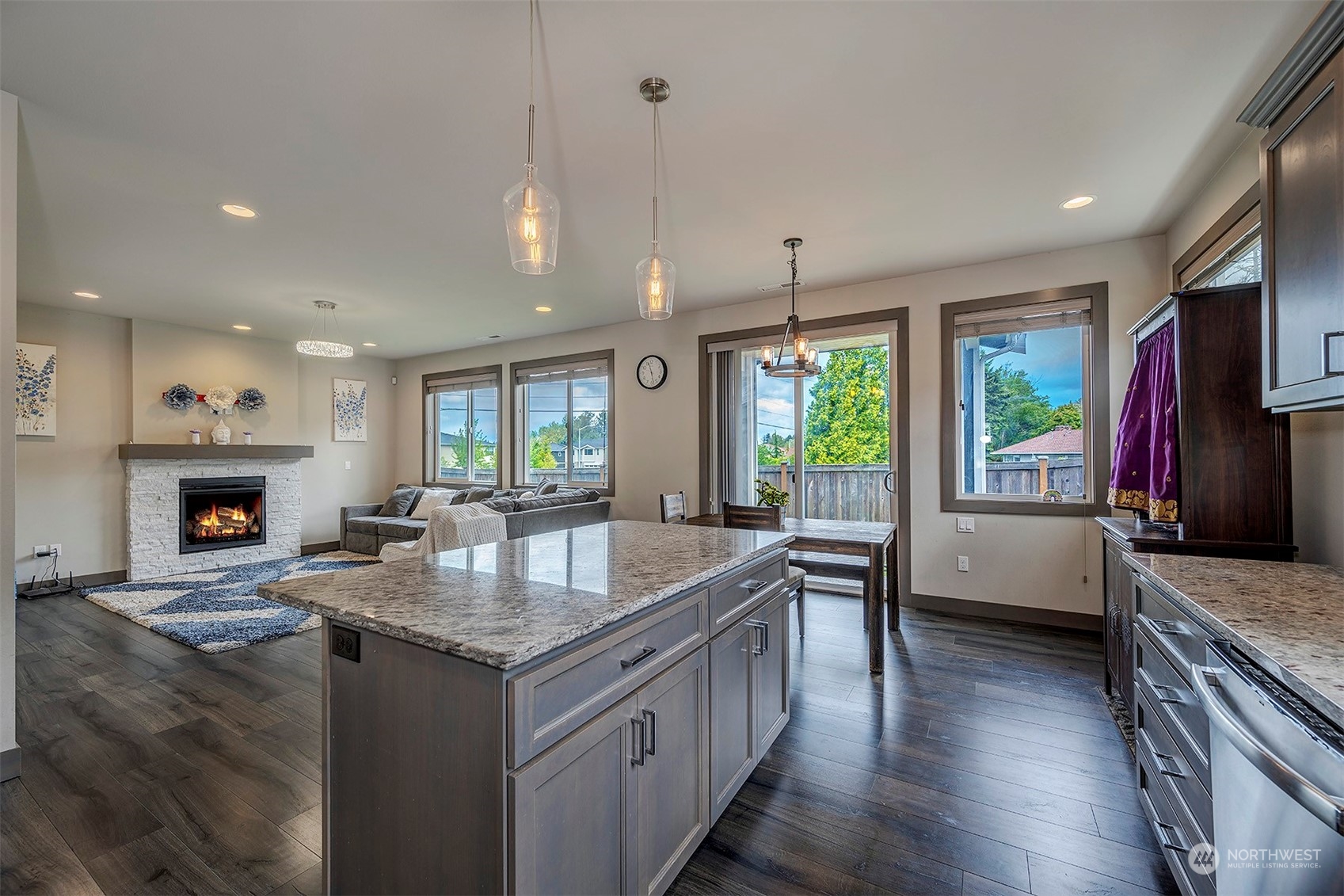 4015 147th Place Southeast Bothell, WA 98012 - Photo 15 of 31 a kitchen with granite countertop center island wooden floor appliances and a window