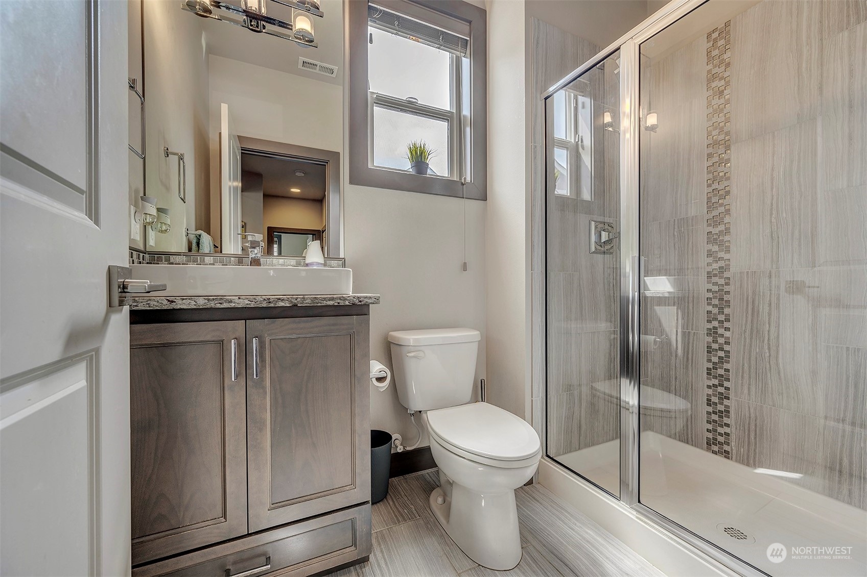 4015 147th Place Southeast Bothell, WA 98012 - Photo 17 of 31 a bathroom with a granite countertop sink a toilet and shower