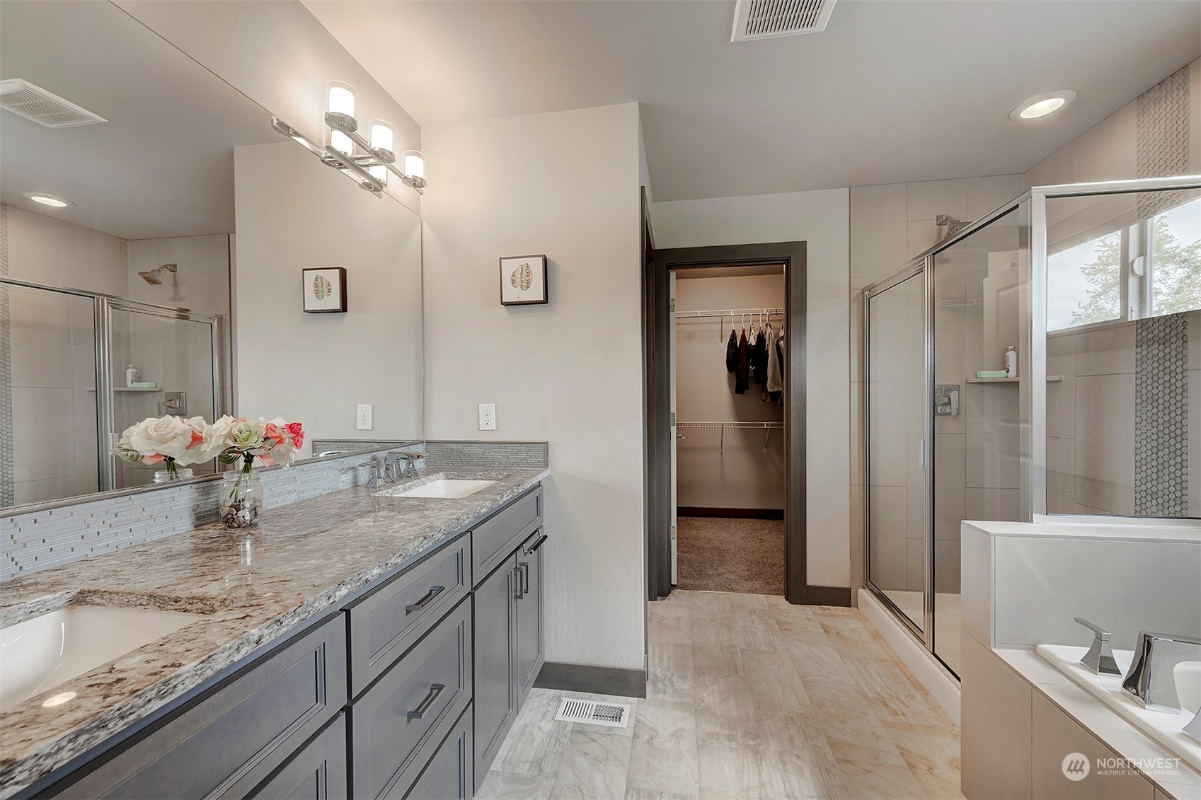 4015 147th Place Southeast Bothell, WA 98012 - Photo 20 of 31 a bathroom with a granite countertop sink a toilet a large mirror and shower